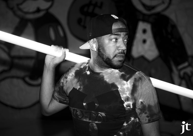 Black-and-white portrait holding a tube light